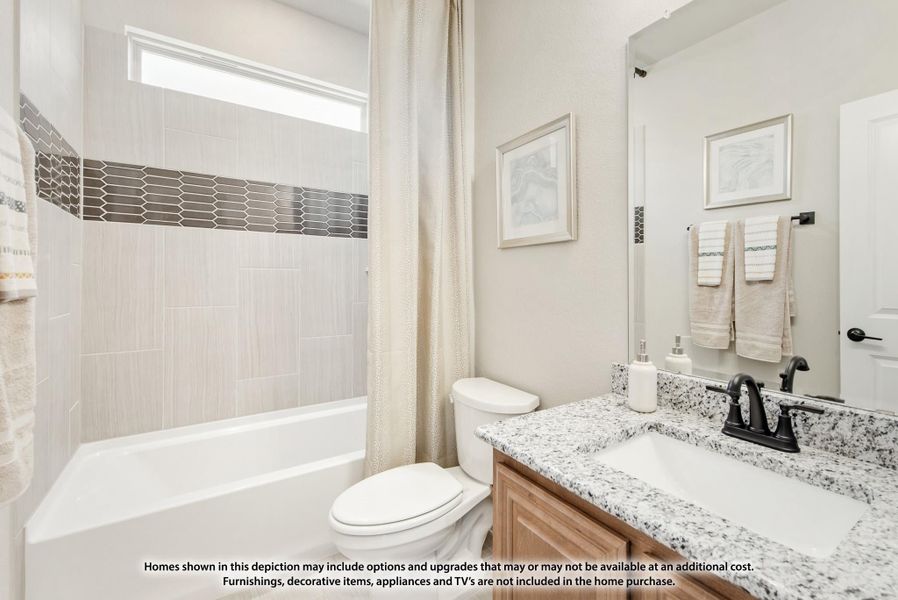 Bathroom with granite countertop vanity, tub-shower combo with tile surround, and dark bronze faucet fixtures Bathroom with granite countertop vanity, tub-shower combo with tile surround, and dark bronze faucet fixtures