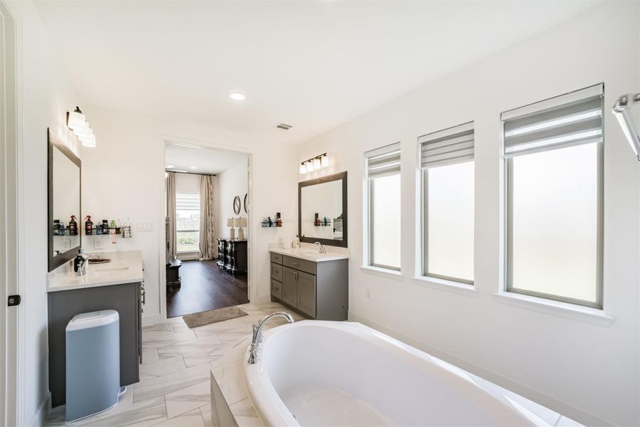 A view of the primary bedroom leading into the primary suite. A view of the primary bedroom leading into the primary suite.