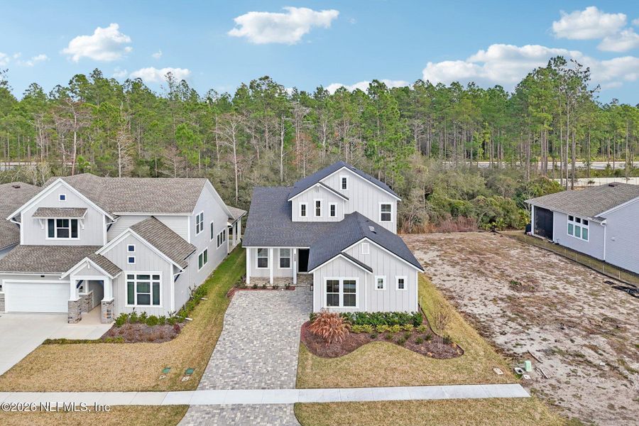 Front exterior of a new home in Middlebourne, St. Johns, FL, highlighting curb appeal (Image 30). Front exterior of a new home in Middlebourne, St. Johns, FL, highlighting curb appeal (Image 30).