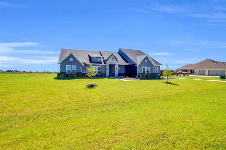 Front exterior of a new home in Springside Estates II, Waxahachie, TX, highlighting curb appeal (Image 19). Front exterior of a new home in Springside Estates II, Waxahachie, TX, highlighting curb appeal (Image 19).