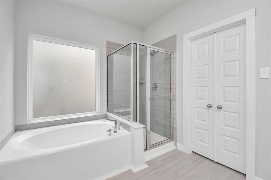 The primary en-suite has a soaking tub to give you that spa experience. The large privacy window allow lots of nature light in the space.