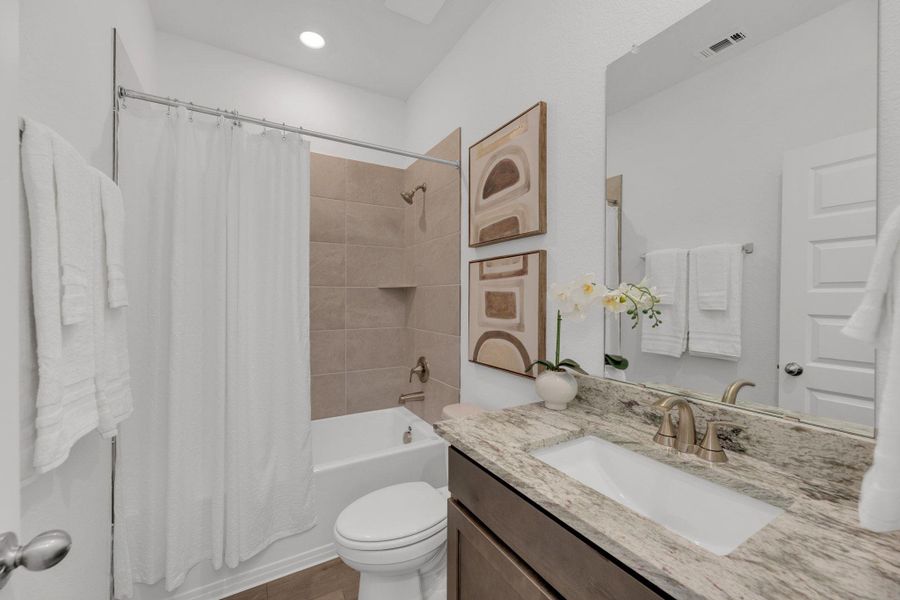 Bathroom featuring shower / bath combo with shower curtain and vanity Bathroom featuring shower / bath combo with shower curtain and vanity