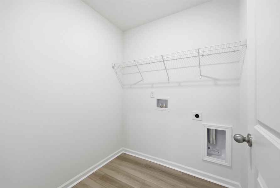 Washroom featuring light wood-style flooring, hookup for a washing machine, and hookup for an electric dryer Washroom featuring light wood-style flooring, hookup for a washing machine, and hookup for an electric dryer