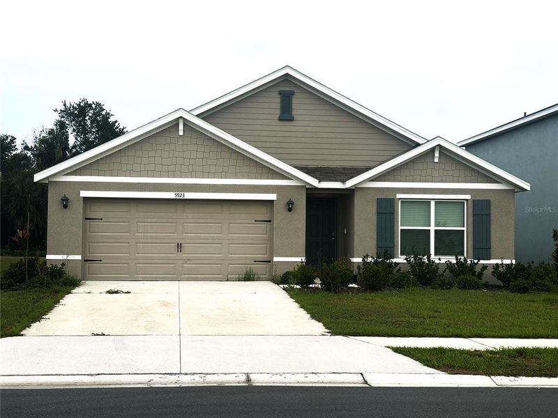 Front exterior of a new home in Silverstone North, Palmetto, FL, highlighting curb appeal (Image 24).