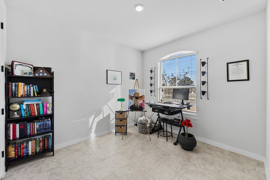 Home office with baseboards and light tile patterned floors