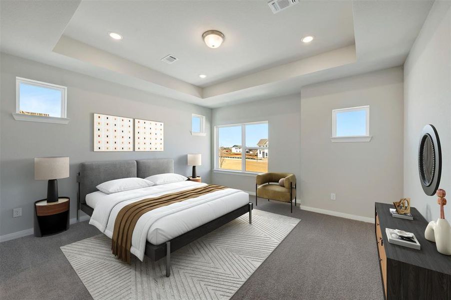 Carpeted bedroom featuring multiple windows, recessed lighting, and a tray ceiling