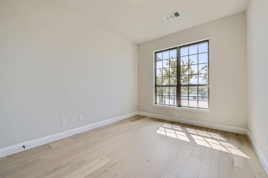 Unfurnished room with a healthy amount of sunlight and light wood-type flooring