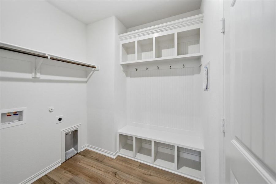 Laundry area with light wood finished floors, gas dryer hookup, electric dryer hookup, and washer hookup