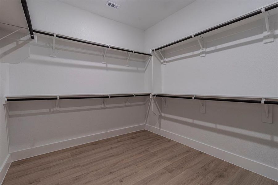 Walk in closet featuring light wood-style flooring