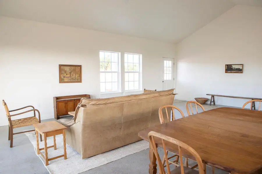 Dining space featuring vaulted ceiling and baseboards Dining space featuring vaulted ceiling and baseboards