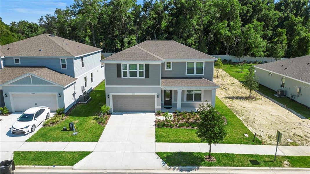 Front exterior of a new home in Winding Meadows, Apopka, FL, highlighting curb appeal (Image 24).