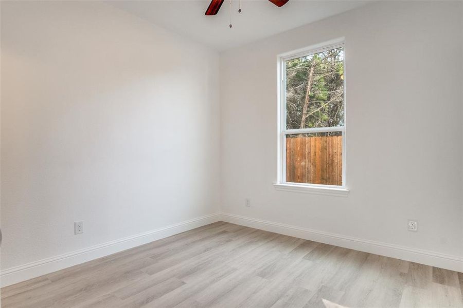 Spare room with a ceiling fan and light wood finished floors Spare room with a ceiling fan and light wood finished floors