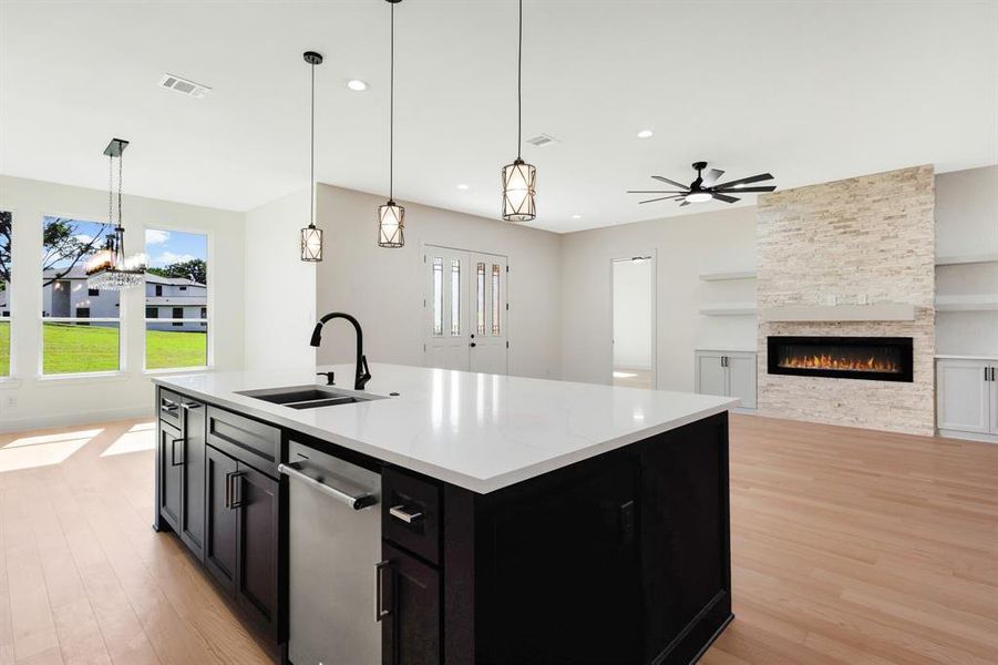 Spacious kitchen island with a white countertop and dark wood-finish cabinetry Spacious kitchen island with a white countertop and dark wood-finish cabinetry