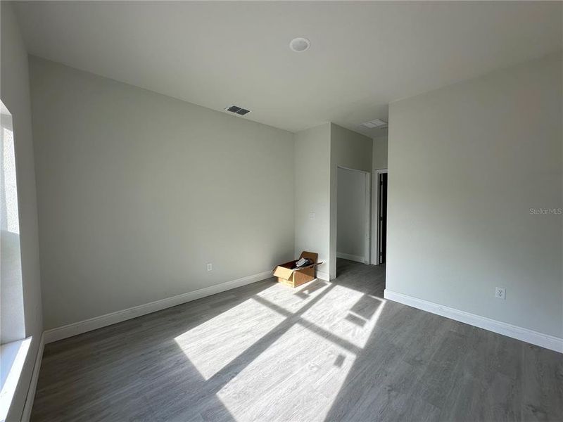 Primary bedroom with walk-in closet and ensuite bathroom on the right