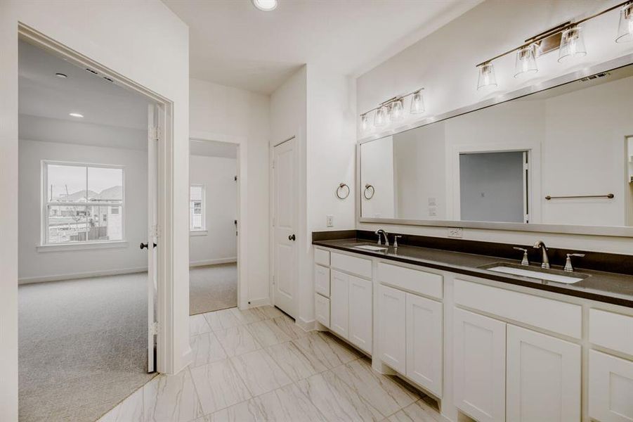 Dual vanity with dark countertops and integrated sinks