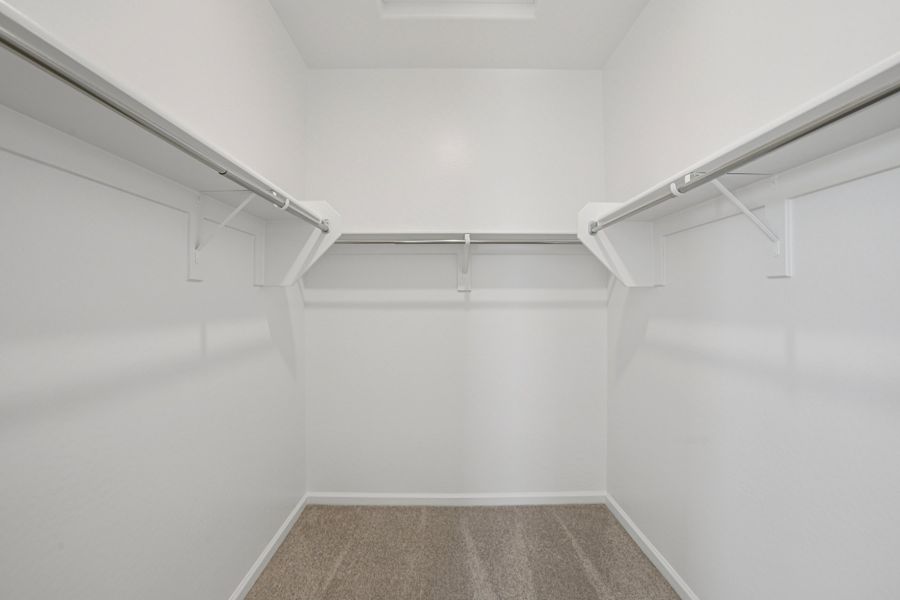 Primary walk in closet. Finishes and options may vary by community.