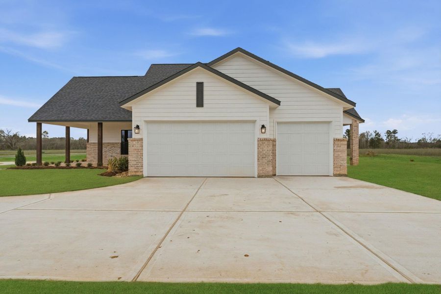 Front exterior of a new home in High Meadow Estates, New Waverly, TX, highlighting curb appeal (Image 27).