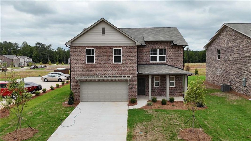 Front exterior of a new home in Kendall Grove, McDonough, GA, highlighting curb appeal (Image 1). Front exterior of a new home in Kendall Grove, McDonough, GA, highlighting curb appeal (Image 1).