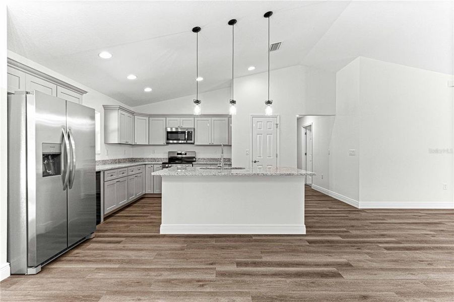 KITCHEN ISLAND HAS A LARGE DOUBLE BOWL SINK IWTH DISHWASHER AND PLENTY OF CABINETS