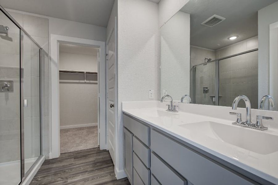 A bathroom with a glass shower. A bathroom with a glass shower.