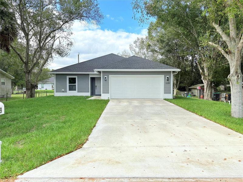 Front exterior of a new home in , Okeechobee, FL, highlighting curb appeal (Image 28).