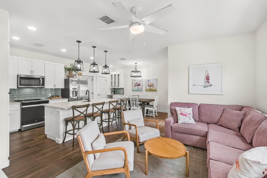 Living area with dark wood-type flooring, recessed lighting, and a ceiling fan Living area with dark wood-type flooring, recessed lighting, and a ceiling fan