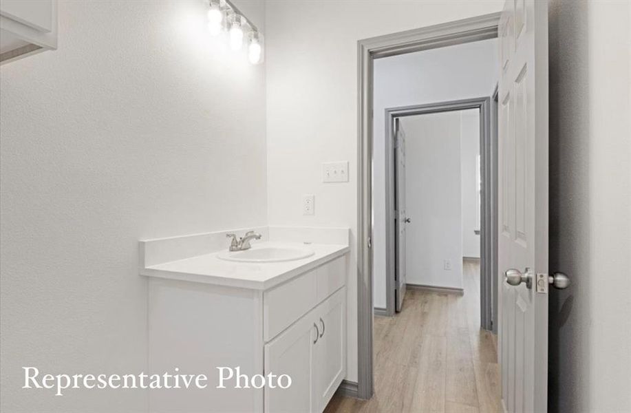 Bathroom featuring hardwood / wood-style floors and vanity