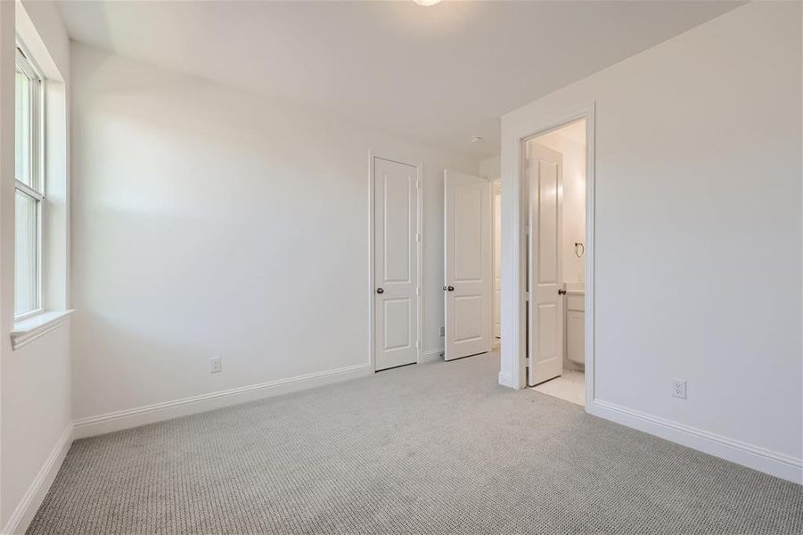 Unfurnished room with a healthy amount of sunlight and light colored carpet