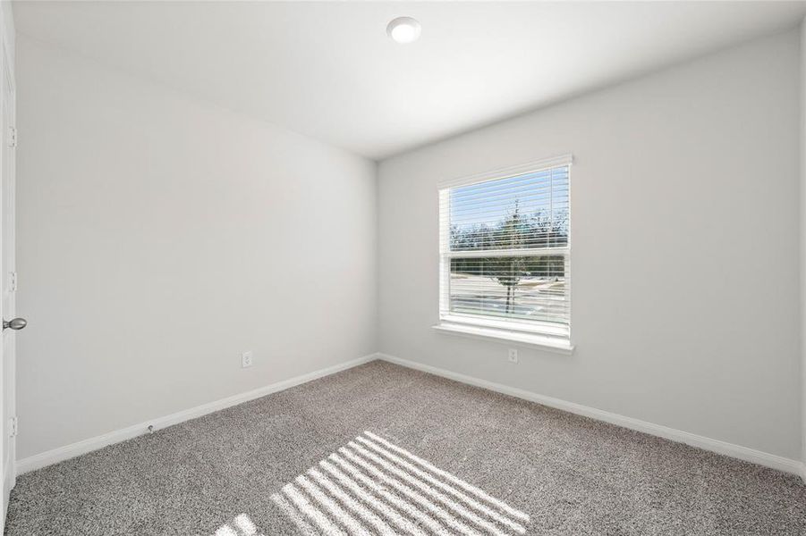 Spare room with carpet flooring and baseboards