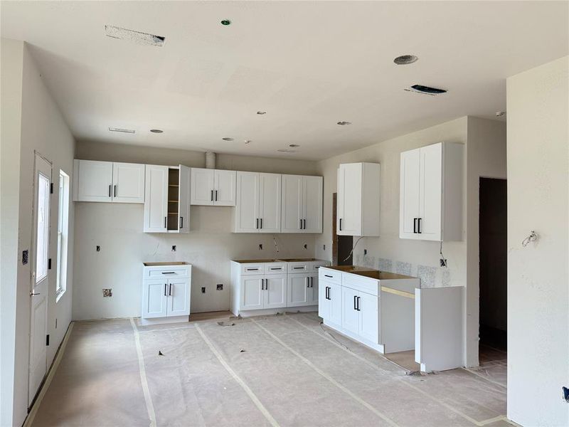 Kitchen featuring white cabinetry and recessed lighting Kitchen featuring white cabinetry and recessed lighting