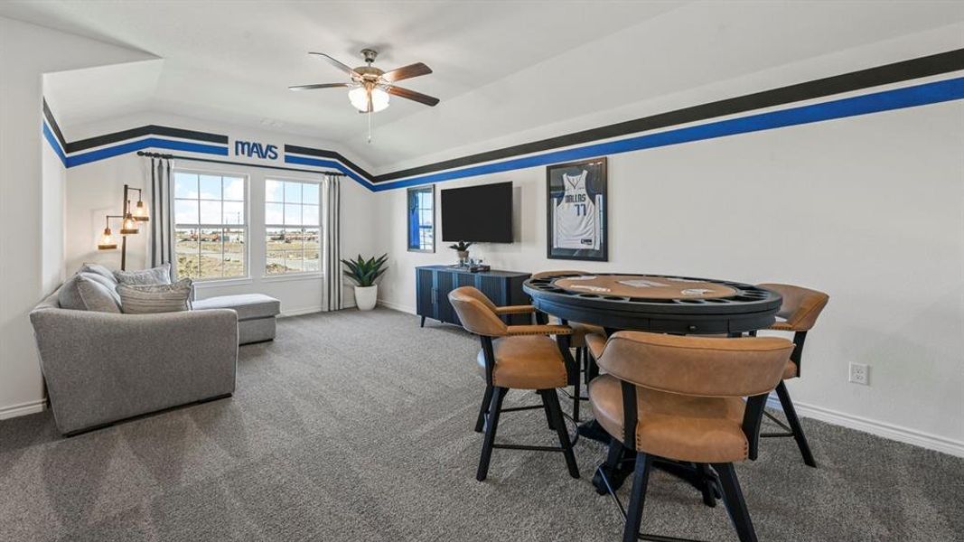 Spacious bonus room featuring vaulted ceilings, a ceiling fan, and carpet flooring Spacious bonus room featuring vaulted ceilings, a ceiling fan, and carpet flooring