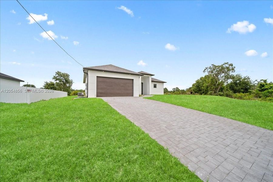 Front exterior of a new home in , Lehigh Acres, FL, highlighting curb appeal (Image 2). Front exterior of a new home in , Lehigh Acres, FL, highlighting curb appeal (Image 2).