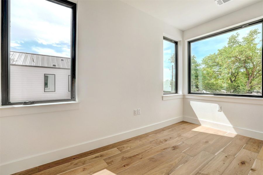 Unfurnished room featuring light wood-style flooring and baseboards