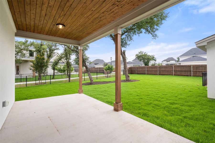 A spacious covered patio offers a refreshing outdoor living area, overlooking a private green yard. A spacious covered patio offers a refreshing outdoor living area, overlooking a private green yard.