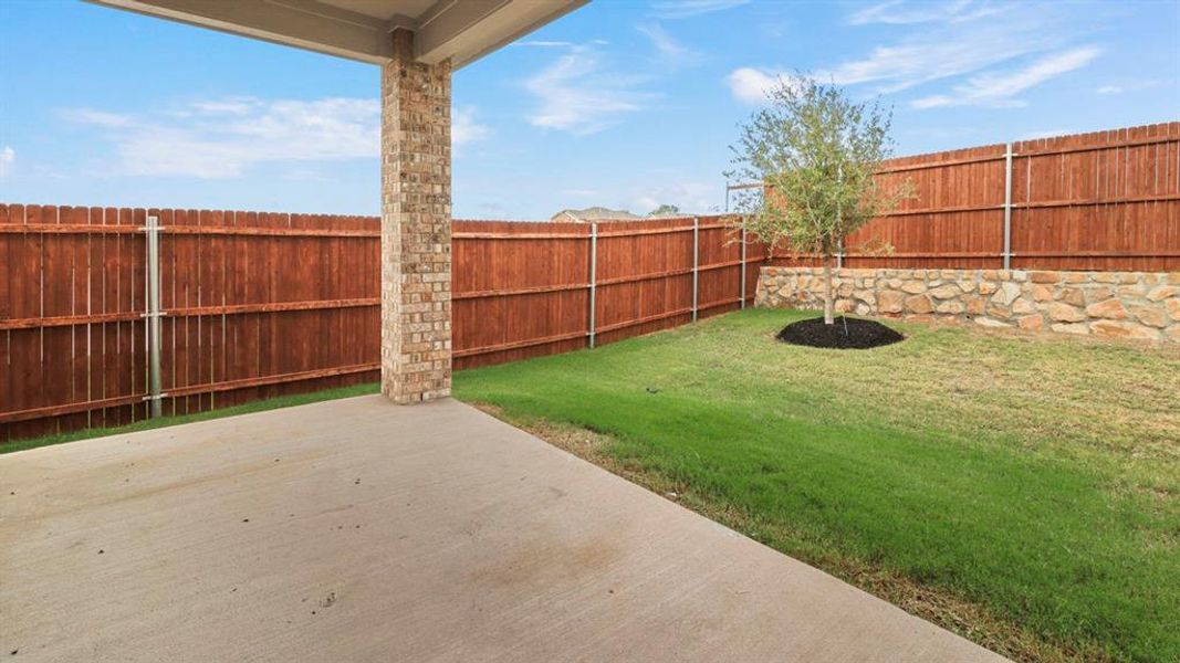 Fenced backyard with a patio
