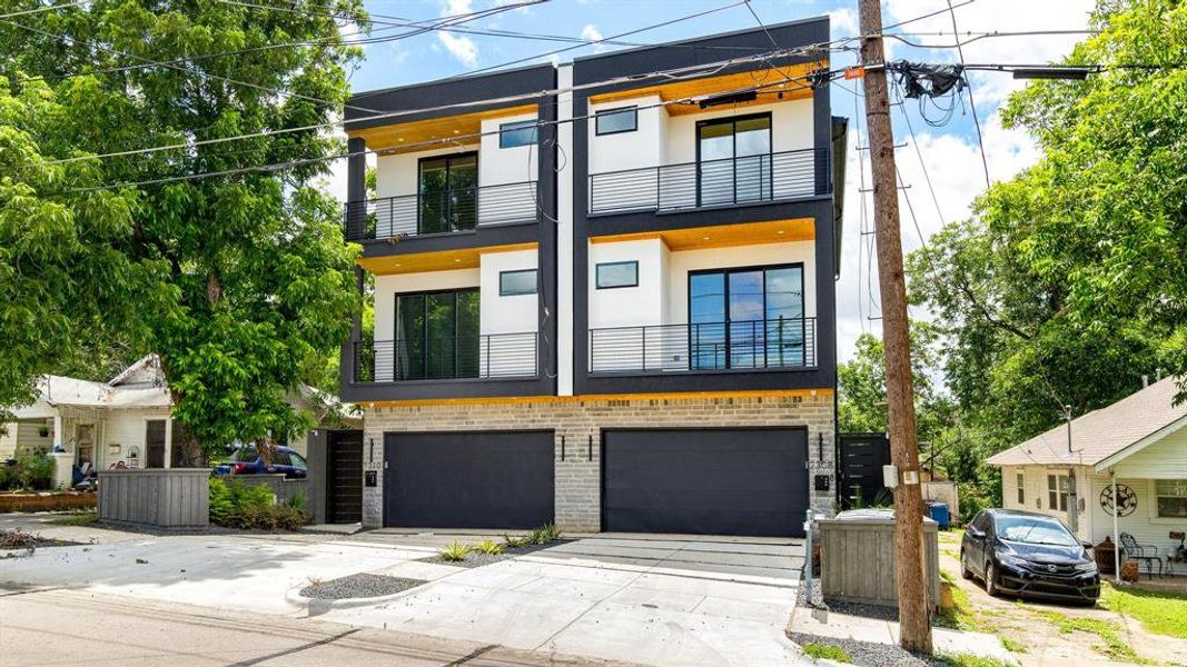 View of front of property with a garage and a balcony