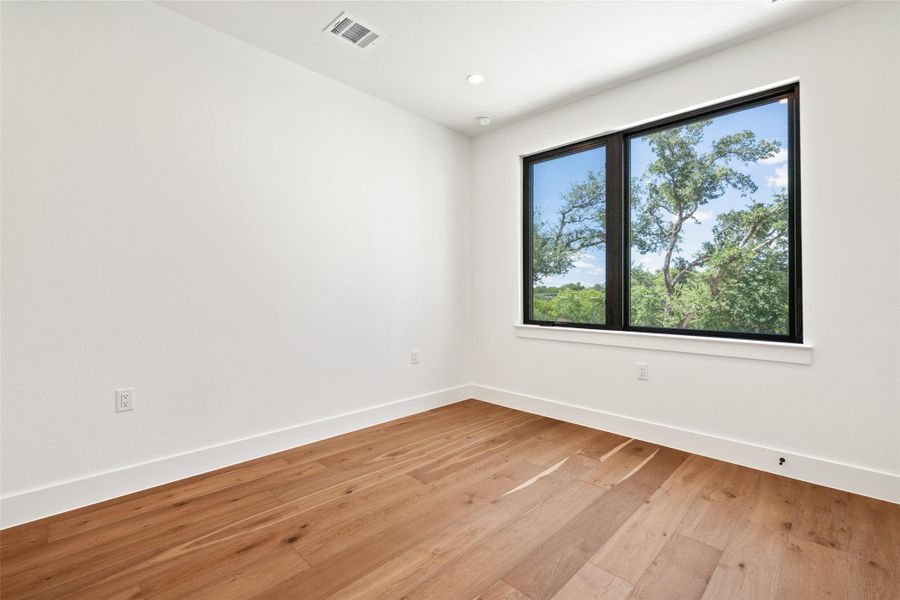 Spare room featuring light wood-type flooring and recessed lighting