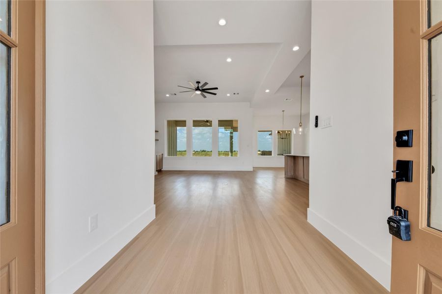 Welcoming entry opens to a spacious family room with soaring ceilings, large windows, and abundant natural light. Welcoming entry opens to a spacious family room with soaring ceilings, large windows, and abundant natural light.