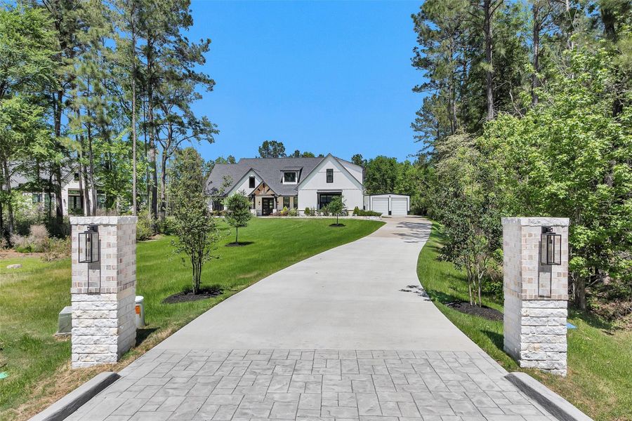Long driveway with additional parking and 4-car garage