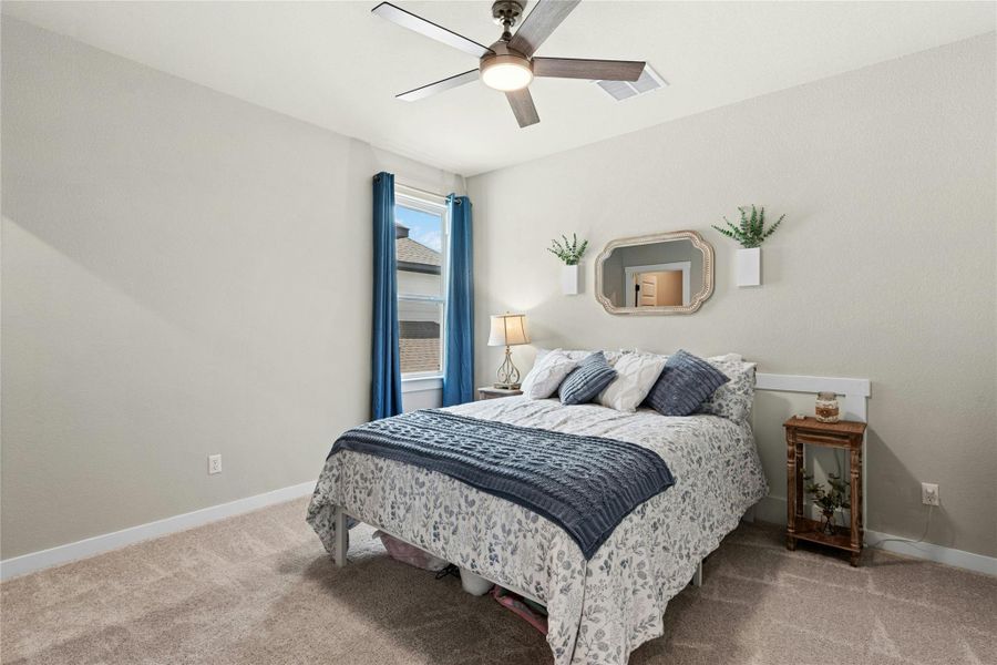 Bedroom with light carpet and ceiling fan