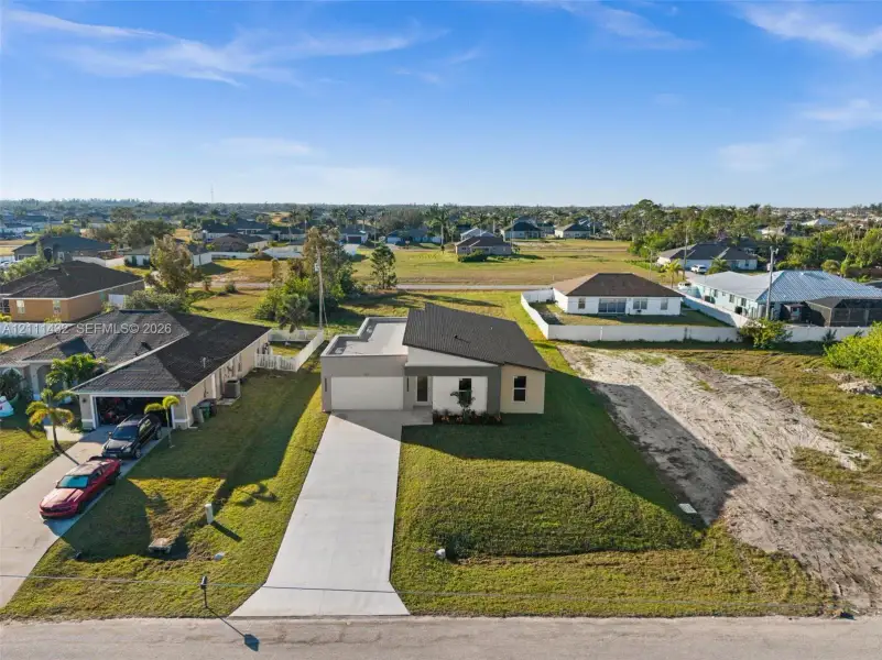 Front exterior of a new home in , Cape Coral, FL, highlighting curb appeal (Image 1). Front exterior of a new home in , Cape Coral, FL, highlighting curb appeal (Image 1).