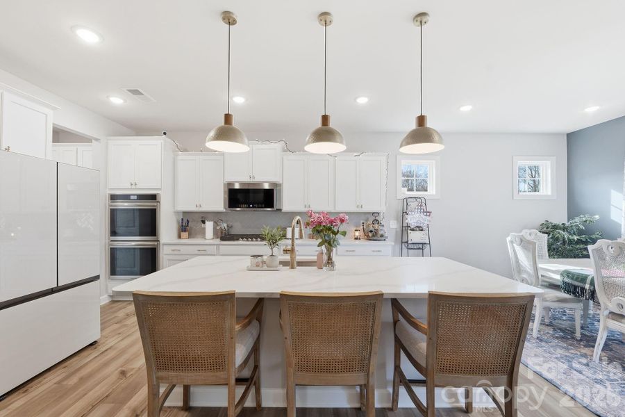 The substantial kitchen island acts as a perfect gathering area for your loved ones to enjoy afternoon snacks, catch up on the day's tasks, or serve up a game day feast when guests stop by for a visit