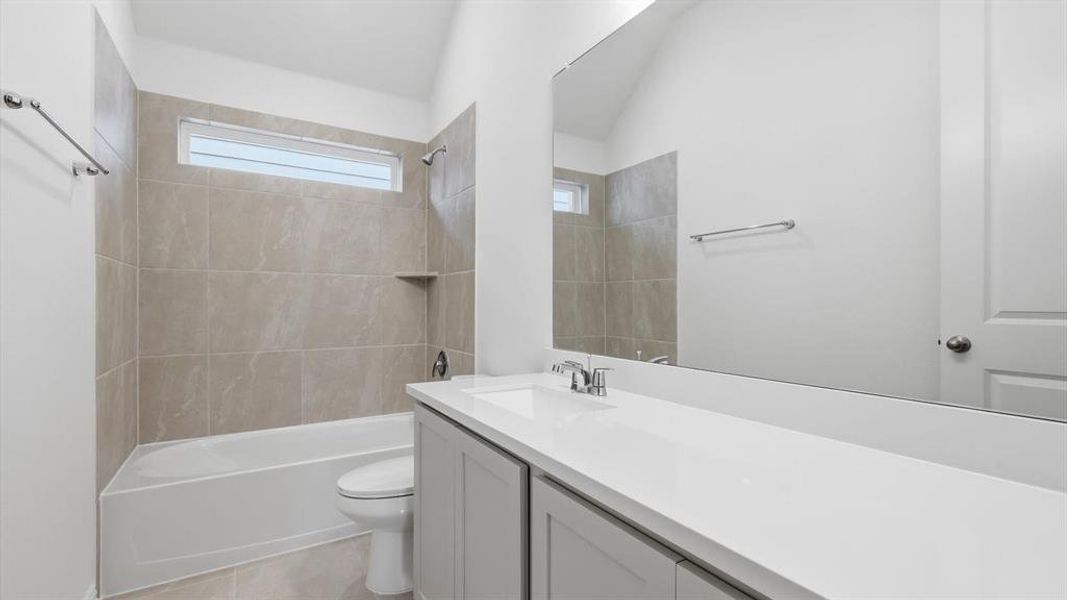 Neutral tile-surround tub/shower combination with a built-in shelf Neutral tile-surround tub/shower combination with a built-in shelf