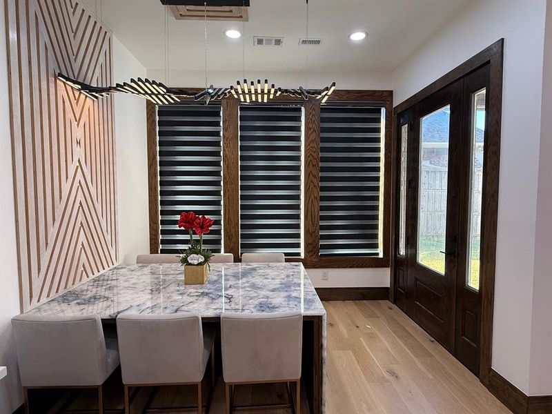 Dining room featuring light wood finished floors and recessed lighting
