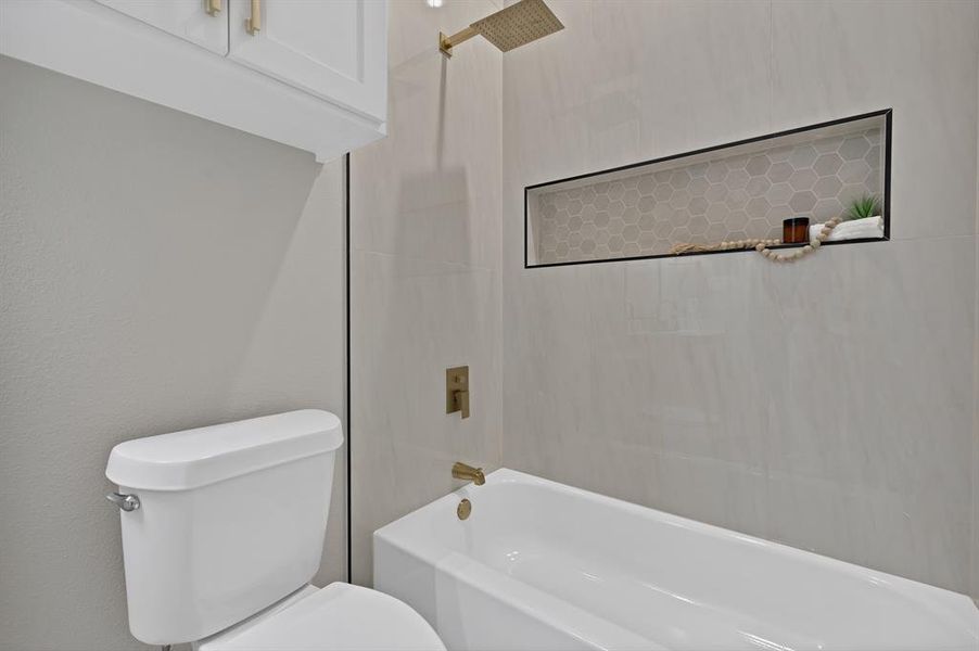 Full bath featuring toilet and shower / washtub combination
