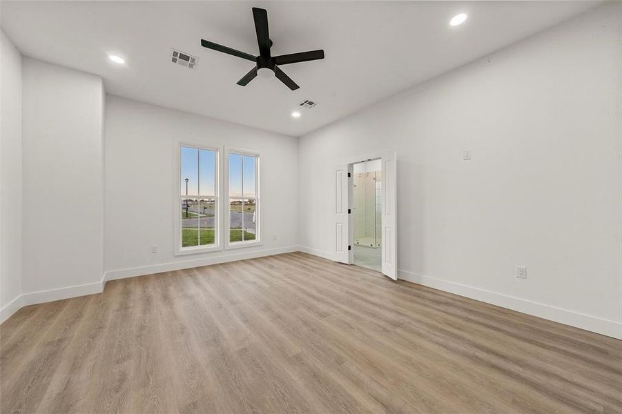 Unfurnished room with light wood finished floors, a ceiling fan, and recessed lighting Unfurnished room with light wood finished floors, a ceiling fan, and recessed lighting