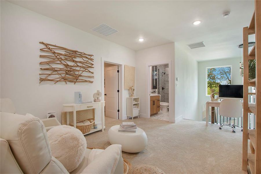 Living room with a desk, carpet flooring, and recessed lighting Living room with a desk, carpet flooring, and recessed lighting