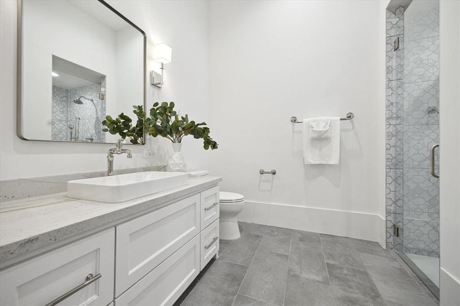 1ST FLOOR FULL BATH: A discreetly located en-suite bathroom ensures the utmost convenience for guests or occupants utilizing the space as a bedroom.Stunning walk-in shower in the first floor bathroom