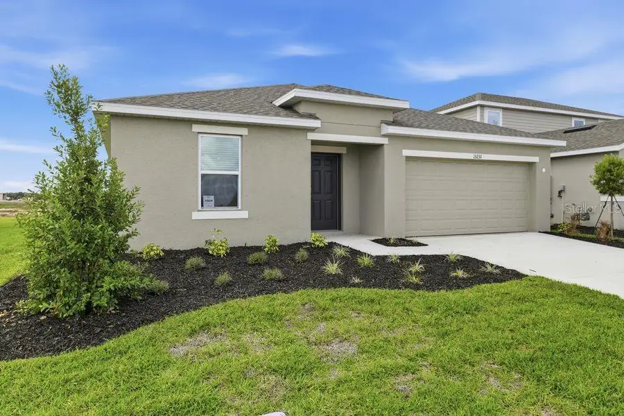 Front exterior of a new home in Firethorn, Parrish, FL, highlighting curb appeal (Image 21).