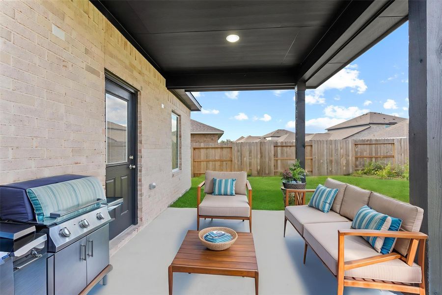 Step outside to your covered patio—perfect for weekend barbecues, morning coffee, or simply relaxing while enjoying your private, fenced yard. *Virtually Stage Photo*